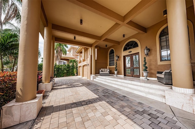 view of patio / terrace featuring a garage and french doors