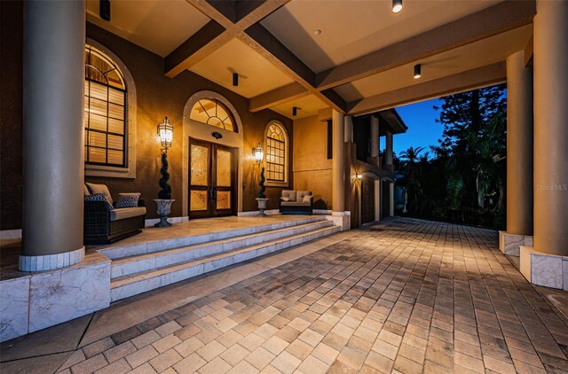 patio terrace at dusk with an outdoor hangout area and french doors