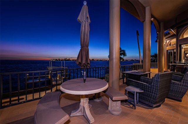 patio terrace at dusk with a water view