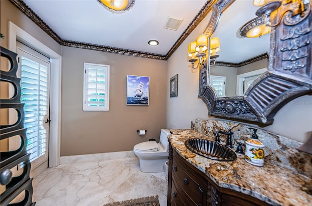 bathroom with crown molding, toilet, tile floors, and large vanity