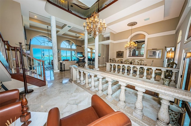 dining room featuring a notable chandelier, a raised ceiling, a high ceiling, tile floors, and coffered ceiling