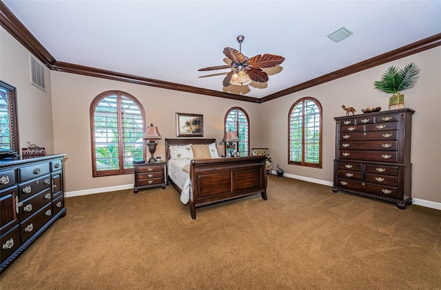 carpeted bedroom with ceiling fan, multiple windows, and ornamental molding