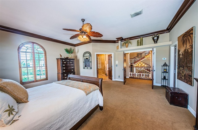 carpeted bedroom with ensuite bath, ceiling fan, and ornamental molding