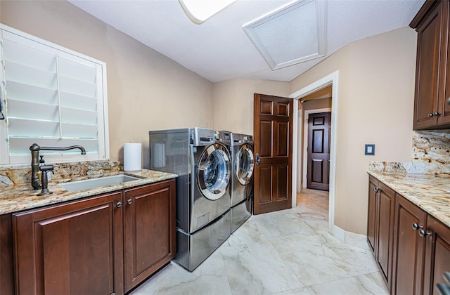 laundry area with washer and dryer, cabinets, sink, and light tile floors