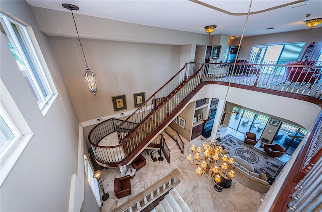 staircase with a high ceiling and tile floors