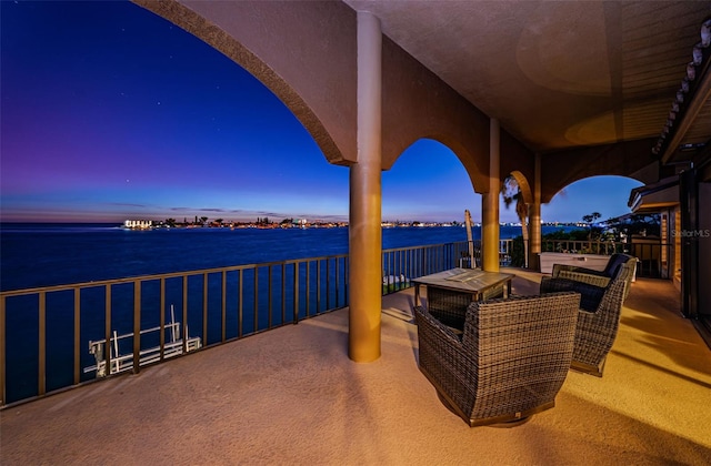 patio terrace at dusk with a water view