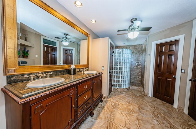 bathroom with tile floors, large vanity, ceiling fan, and double sink