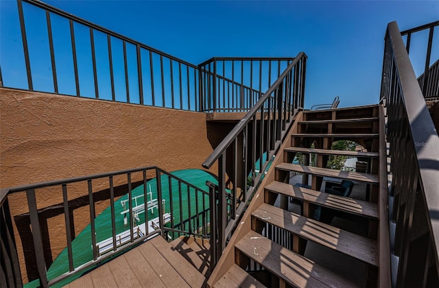 stairway featuring wood-type flooring