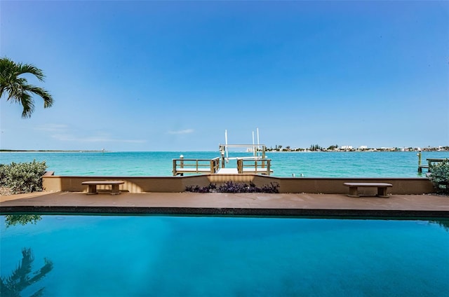 view of pool with a water view