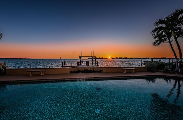 pool at dusk with a water view