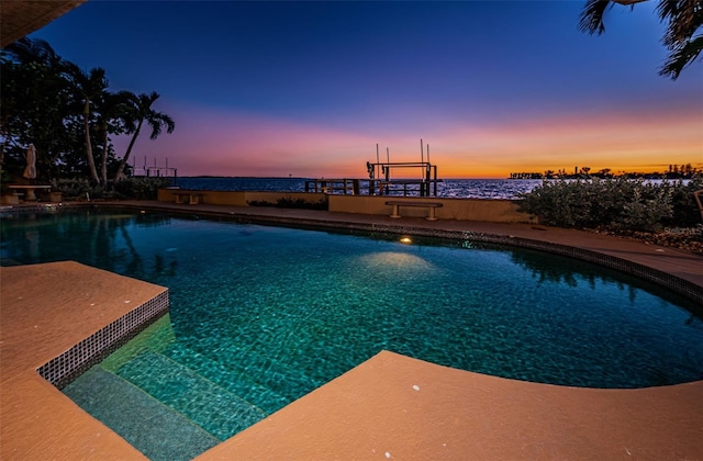 view of pool at dusk