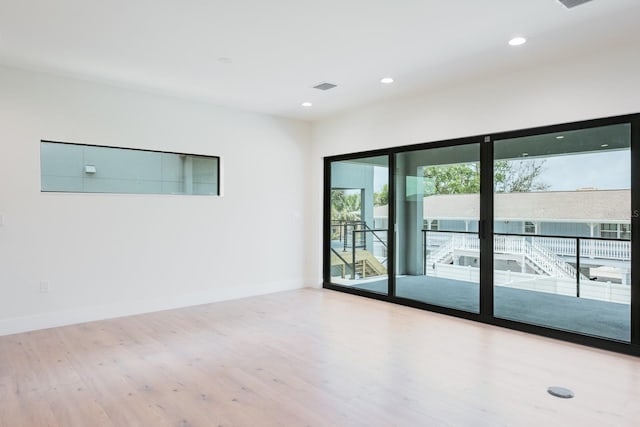 empty room with hardwood / wood-style flooring