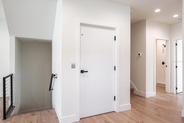 corridor with light wood-type flooring