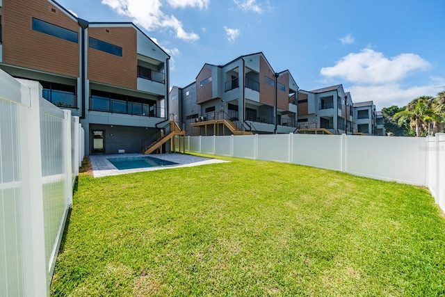 view of yard with a balcony