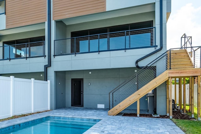 back of house featuring a fenced in pool