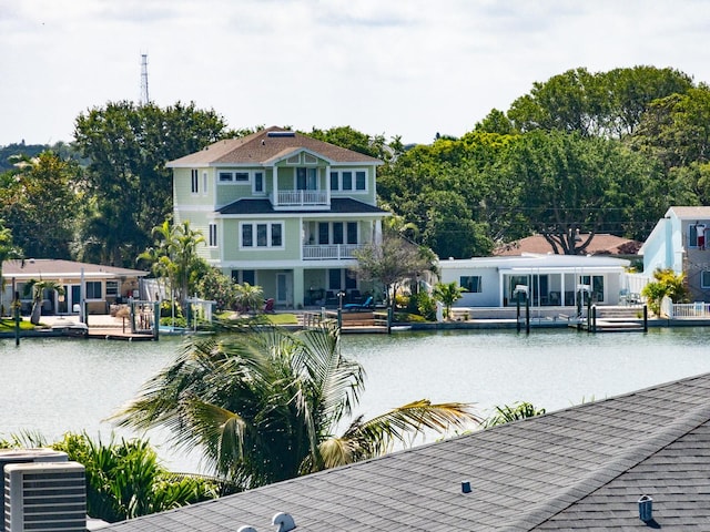 dock area with a balcony, a water view, and central AC unit