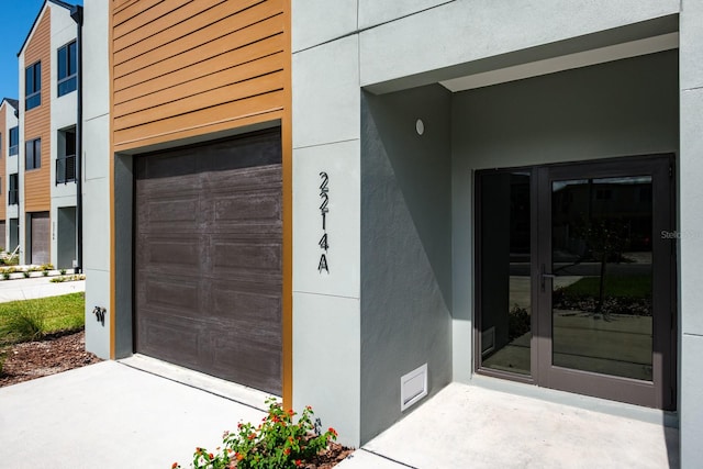 view of exterior entry with a garage