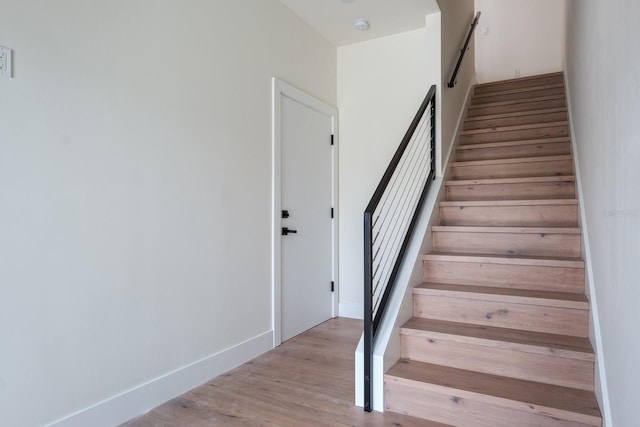 stairs featuring light hardwood / wood-style floors