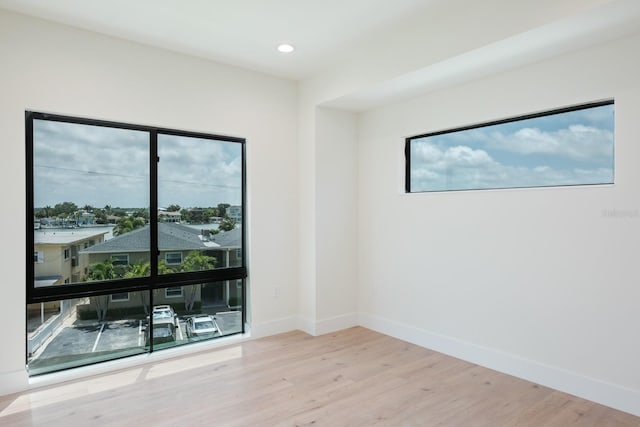 spare room featuring light hardwood / wood-style flooring