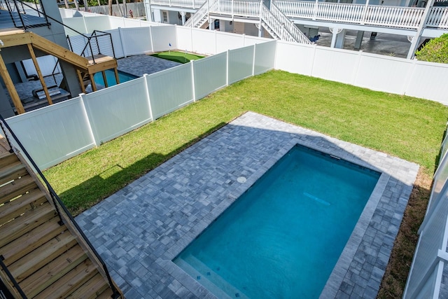 view of swimming pool with a patio and a yard