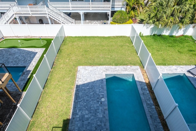 view of yard with a patio area and a fenced in pool