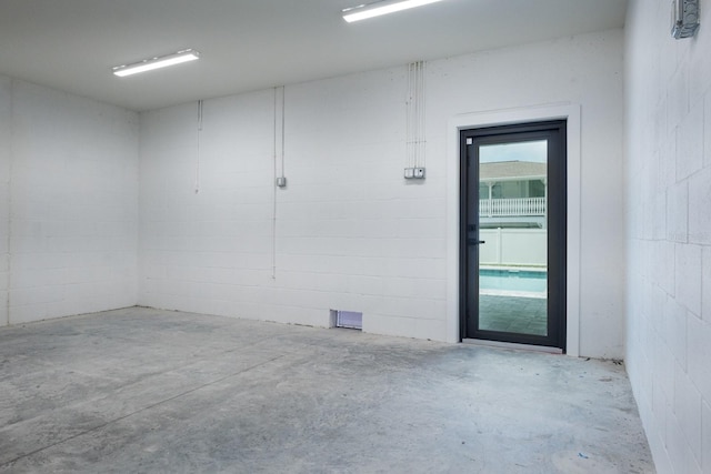 unfurnished room featuring concrete flooring