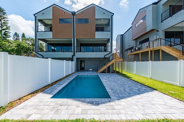 back of house featuring a patio area, a fenced backyard, and stairway