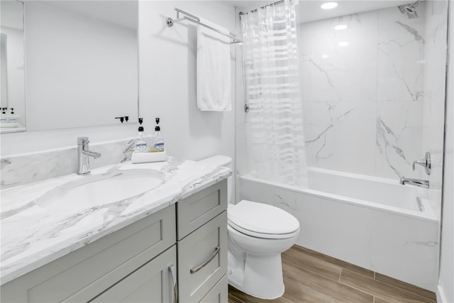 full bathroom featuring shower / bath combo, wood-type flooring, toilet, and vanity