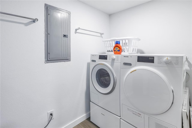 laundry room featuring separate washer and dryer and hardwood / wood-style flooring