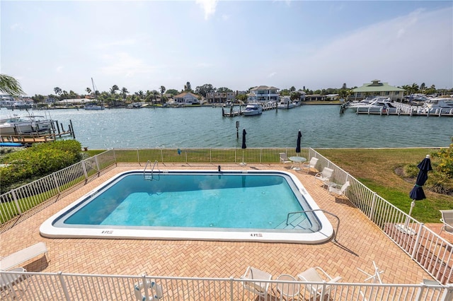 view of pool with a water view and a dock