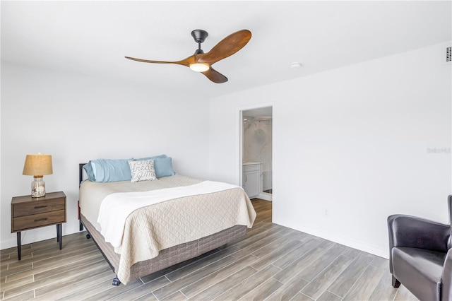 bedroom with hardwood / wood-style flooring, ensuite bathroom, and ceiling fan