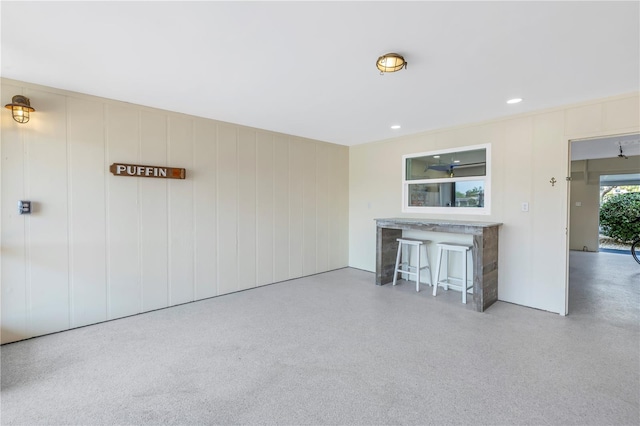 unfurnished living room featuring bar area