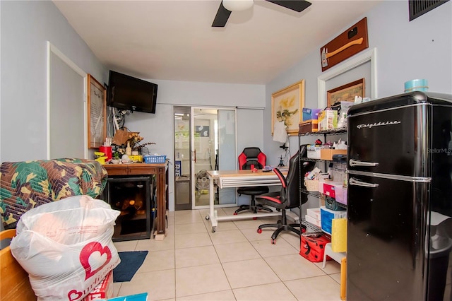 tiled office space featuring ceiling fan