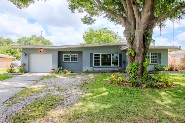 ranch-style home with a front yard and a garage