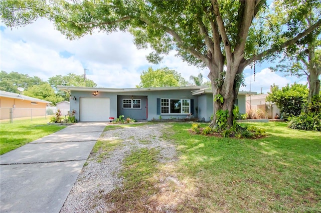 ranch-style home with a garage and a front lawn