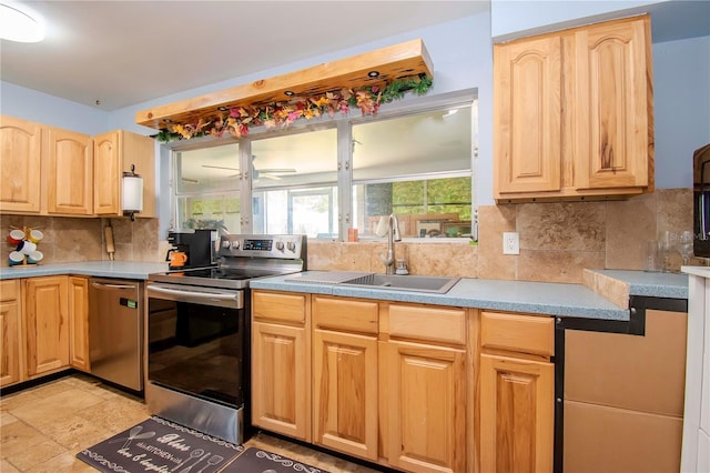 kitchen with appliances with stainless steel finishes, backsplash, light brown cabinetry, and sink