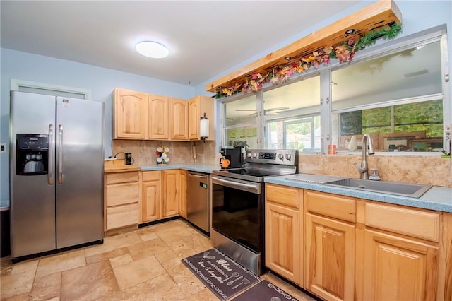 kitchen with stainless steel appliances, backsplash, light brown cabinets, and sink