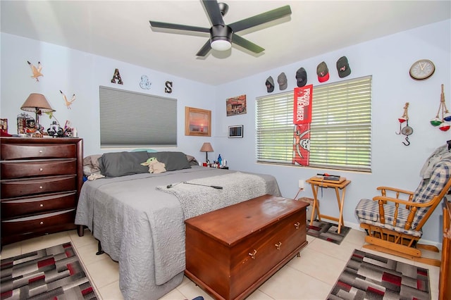 tiled bedroom featuring ceiling fan