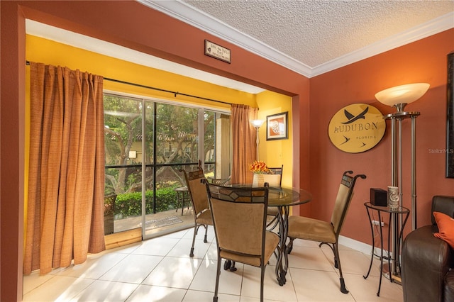 dining room featuring tile floors, ornamental molding, and a textured ceiling