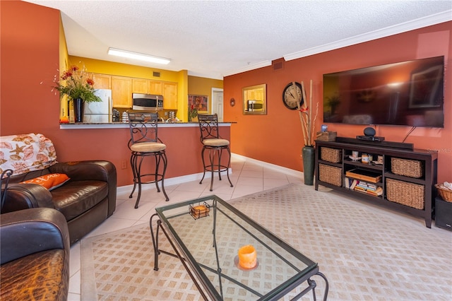 living room with ornamental molding, a textured ceiling, and light tile floors