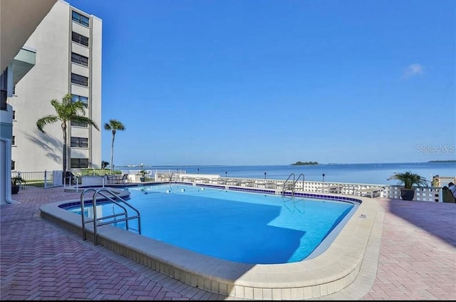 view of swimming pool with a water view