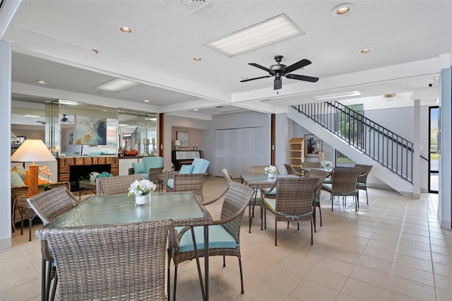 tiled dining room with beamed ceiling and ceiling fan