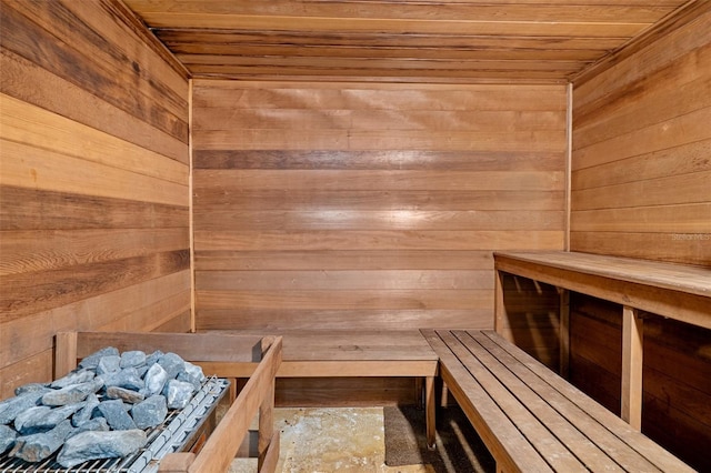 view of sauna featuring wooden walls and wood ceiling