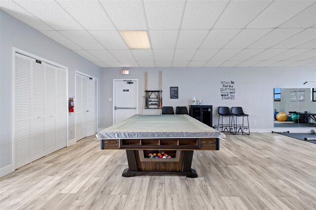 playroom featuring pool table, a paneled ceiling, and light hardwood / wood-style flooring