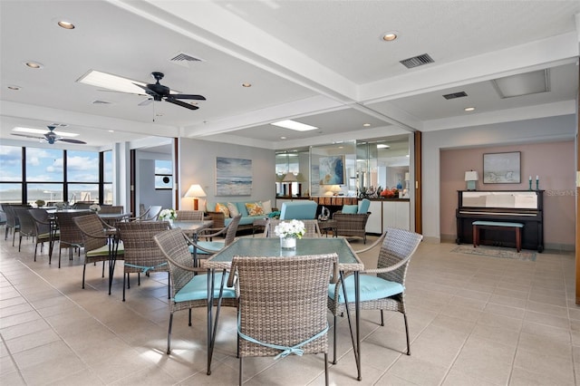 tiled dining space featuring beam ceiling and ceiling fan