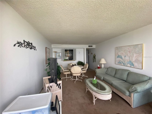 living room featuring carpet floors and a textured ceiling