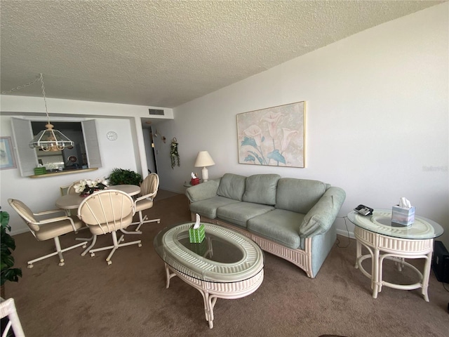 living room featuring carpet flooring and a textured ceiling