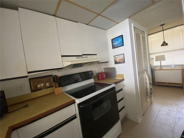 kitchen featuring hanging light fixtures, white cabinetry, white electric stove, light tile floors, and range hood