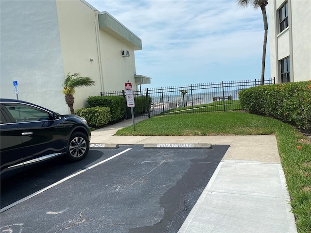 view of car parking featuring a lawn