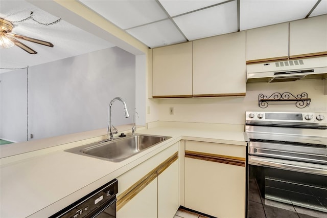 kitchen featuring cream cabinets, sink, light tile patterned floors, and stainless steel range with electric stovetop